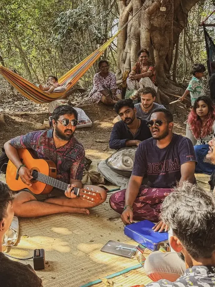 Tejj and friends playing music together outdoors
